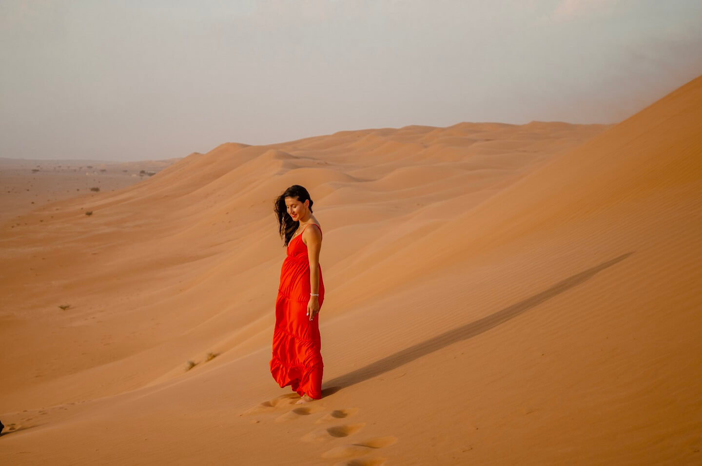 Girl in the red dress at the Wahiba Sands Desert in Oman
