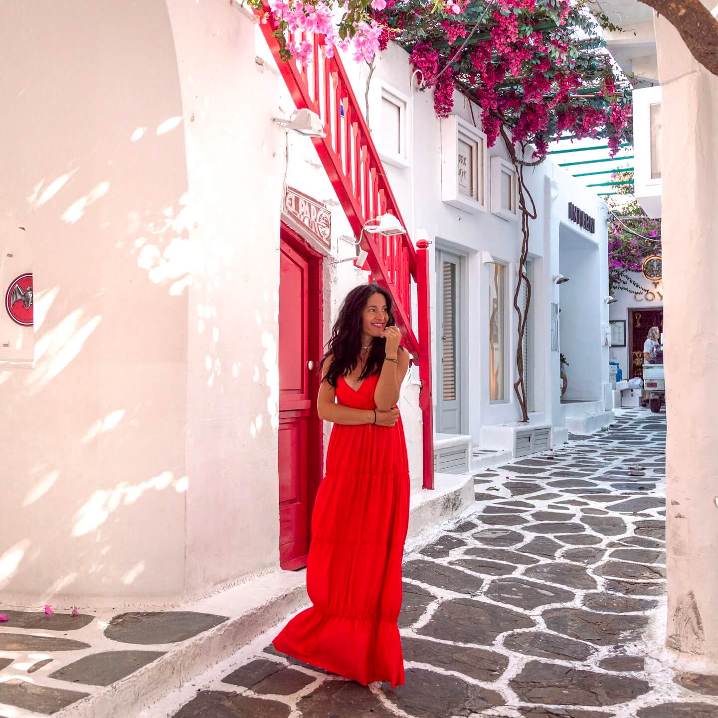 Girl in long red dress poses for instagram