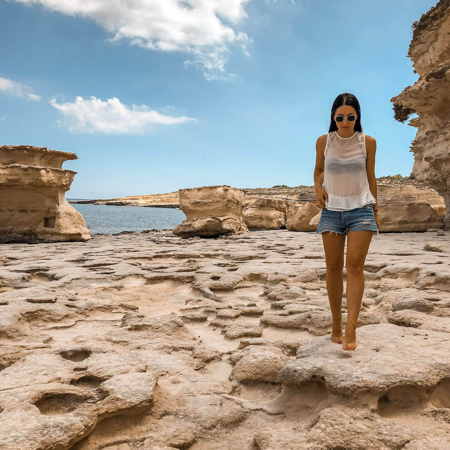 Stella walking on rocky limestone beach