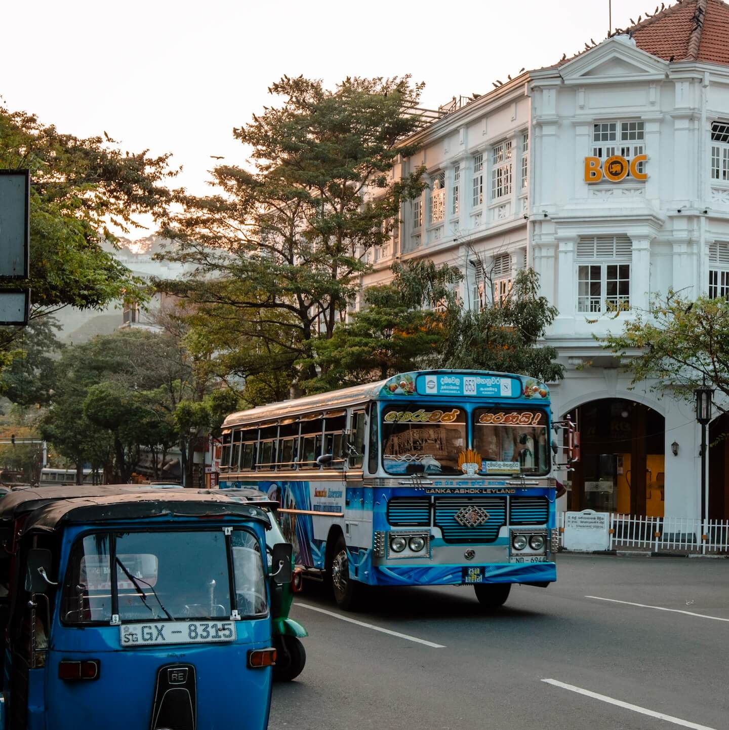 Blue bus and blue tuk tuk on the streets of Kandy in Sri Lanka