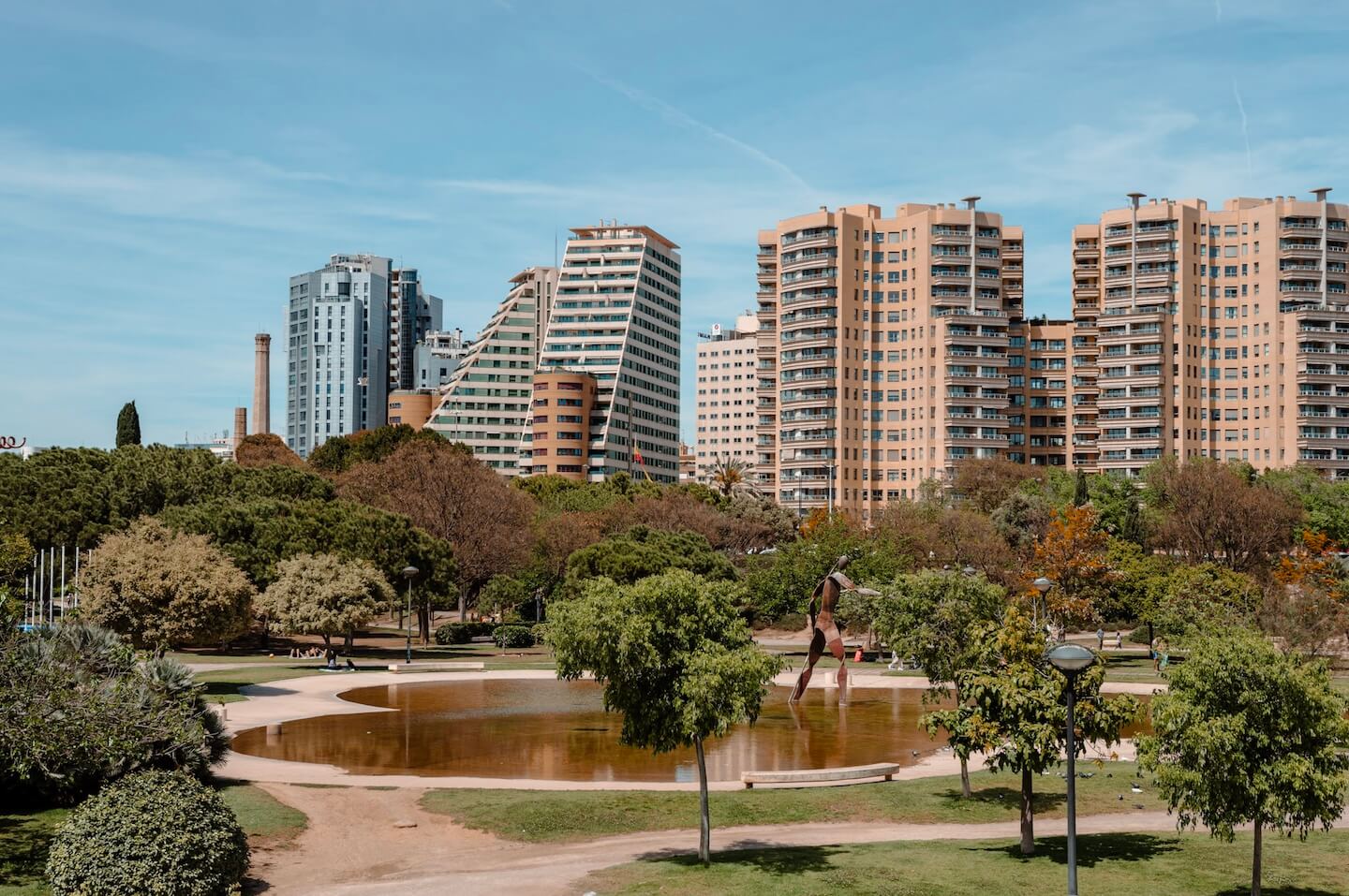 Park in Valencia Spain with tall houses in the back.